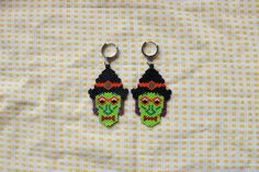 Add some frightfully fun flair to your Halloween ensemble with these one-of-a-kind beaded earrings. With a unique design that packs plenty of personality, these earrings will liven up your look on the spookiest of nights! Booyah! Handmade in Huntsville, AL All of these designs are unique and handmade with love! Snag yourself a pair before they’re gone! Beaded Dangle Earrings For Halloween, Dangle Beaded Earrings For Halloween, Handmade Bohemian Earrings For Halloween, Handmade Green Halloween Earrings, Beaded Earrings For Halloween Party, Halloween Party Beaded Earrings, Beaded Halloween Earrings, Beaded Halloween, Halloween Beads