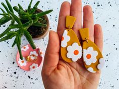 These honeycomb mustard yellow daisy flower polymer clay dangle earrings create a boho spring and easter look. These mustard, white and orange daisy statement earrings are for the boho, hippy, flower child. Turn any outfit into a vintage vibe with these lightweight long dangles. They have a light texture to them and hang on a gold ball.  -Hypoallergenic stainless steel earring backs -Lightweight (less than .1 of an oz!) -Durable + Flexible -Wipes clean of makeup -Small batch + Handmade in the US Orange Drop Earrings For Spring, Handmade Yellow Earrings For Spring, Spring Orange Drop Earrings, Handmade Flower Earrings For Everyday Spring Wear, Handmade Orange Earrings For Spring, Orange Dangle Jewelry For Spring, Trendy Handmade Yellow Flower Earrings, Handmade Everyday Earrings For Spring, Handmade Polymer Clay Flower Earrings