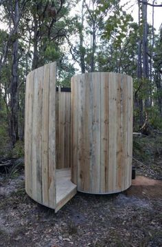 a wooden structure sitting in the middle of a forest