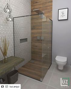 a bathroom with a glass shower door next to a toilet