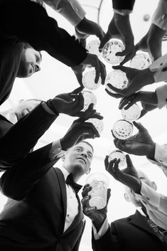 a group of people standing in a circle holding plates