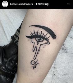 a woman's leg with a black and white tattoo design on the side of her leg