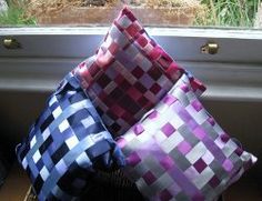 four pillows sitting on top of each other in front of a window