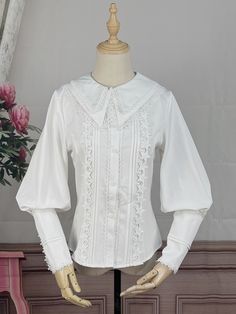 This top features a wide round lace-trimmed shawl collar and balloon sleeves with lace detailing at the collar and cuffs. Plus, when you order now, you'll receive a complimentary detachable collar. The top is adorned with lace-trimmed button placket and accordion pleats, and it also has star embellishments on the front.  Please note that the price includes one top and a free collar, other items are not included.   	 		 			Size 			S 			M 			L 			XL 			2XL 		 		 			Bust 			88 			92 			96 			100 Lace Puff Sleeve Tops With Lace Cuffs, Classic Fall Blouse With Lace Cuffs, Fitted Long Sleeve Blouse With Lace Cuffs, Classic Puff Sleeve Blouse With Lace Trim, Classic Long Sleeve Blouse With Lace Cuffs, Classic Blouse With Lace Trim And Puff Sleeves, White Blouse With Lace Cuffs For Fall, Elegant Tops With Lace Collar And Lantern Sleeve, Elegant Lantern Sleeve Tops With Lace Trim