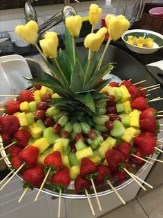 a fruit platter with pineapples, strawberries and bananas