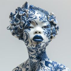 a woman's face painted with blue and white flowers