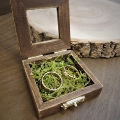 two gold wedding rings in a wooden box