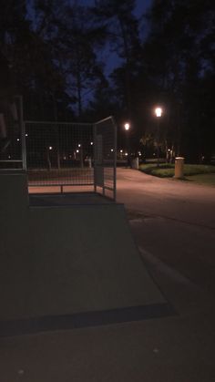 a skateboarder is doing a trick in the air at night time with his board