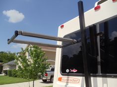 an rv parked in front of a house with the door open and windows partially closed