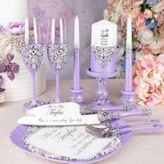 purple and white wedding decor with crystal wine goblets, napkins and candles