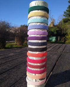 a stack of multicolored ribbons sitting on top of a wooden table