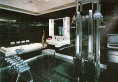 a black and white bathroom with a bathtub, sink, toilet and shower stall