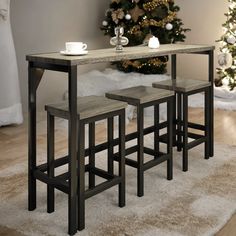 three stools and a table in front of a christmas tree