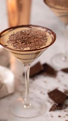 a chocolate martini is garnished with sprinkles on a marble table