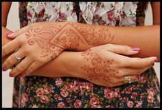 a woman with henna on her arm