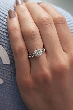 a woman's hand with a ring on her finger and a diamond in the middle