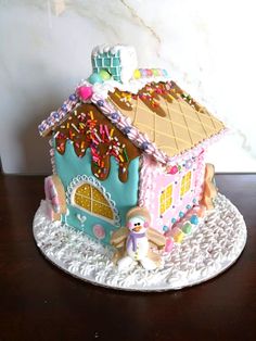 a gingerbread house with sprinkles and icing