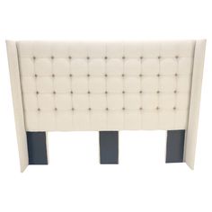 an upholstered headboard with buttons on the back and sides, in white fabric