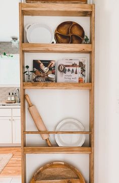 a wooden shelf filled with plates and bowls