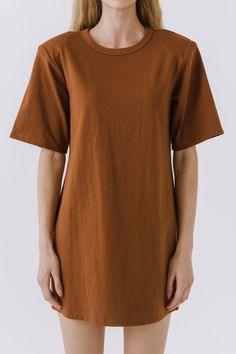 This Shoulder Pad T-Shirt Dress is a wardrobe must-have! Featuring a stylish round neckline, short sleeves, and a boxy silhouette, it's the perfect addition to any outfit. Our unique shoulder pad insert adds structure and a touch of sass, making this dress a standout. With its comfortable fit and comfortability, you'll look amazing no matter what the occasion. Show off your fashion-forward style with this shoulder-pad t-shirt dress! Shoulder pad inserted Round neckline Short sleeves Boxy silhoue Brown Oversized Short Sleeve Dress, Oversized Short Sleeve T-shirt Dress, Solid Color Cotton T-shirt Dress With Crew Neck, Cotton Crew Neck T-shirt Dress, Brown Short Sleeve T-shirt For Work, Jumpsuit Fall, Knit Bottom, Blazer And Shorts, Heat Styling Products