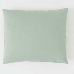 a light green pillow on a white background