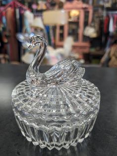 a glass swan sitting on top of a table