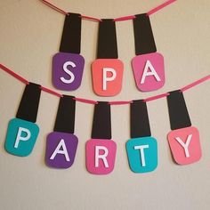 the word spa party spelled out with magnets on a string hanging from a wall