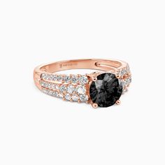 a rose gold ring with black and white diamonds