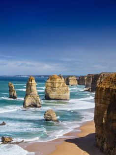 the beach is lined with large rock formations