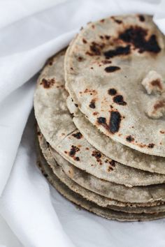 a stack of tortillas sitting on top of a white cloth