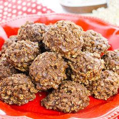 a red plate filled with chocolate peanut butter balls on top of a white and red table cloth