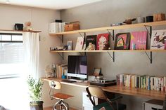 a home office with bookshelves, desk and chair in front of the window