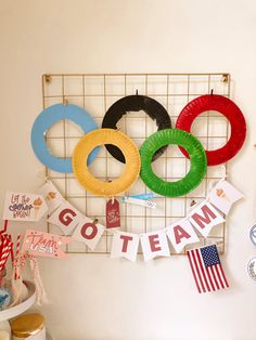 there is a sign that says go team and some paper wreaths hanging on the wall