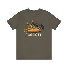 a t - shirt that says taco cat with a cat laying on top of it