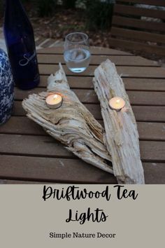 two candles are lit on driftwood tea lights, with the words pinewood tea lights