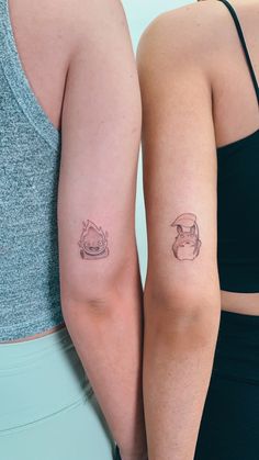 two women with matching tattoos on their arms