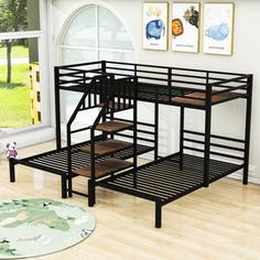 a bunk bed with stairs in front of a window and rug on the floor next to it