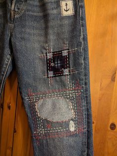 an old pair of jeans with patches on them