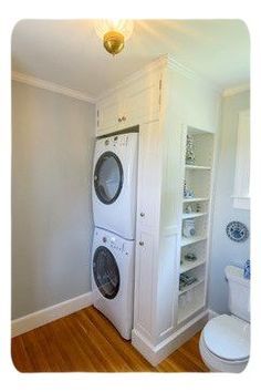 a washer and dryer in a small room with wood flooring on the wooden floors