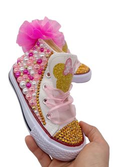 Bling out her birthday party or any occasion with these adorable hand decorated canvas high tops. Shoes feature pink, white and hot pink pearls, a golden mouse with hot pink pom puff and light pink sheer ribbon ties. Perfect for that trip to Disney. Perfect for gifting, birthdays, or anytime. Gently clean decorated areas with damp soapy cloth. Younger children should be supervised due to small parts attached to shoes. Please see shoe size chart in pop-up before ordering. Bedazzle Shoes, High Tops Shoes, Bedazzled Shoes, Diy Bling, Hannah Rose, Funky Dresses, Pink Pearls, Pink Sheer, Bling Shoes