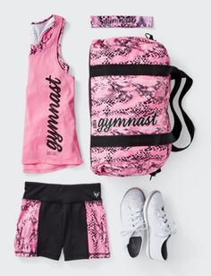 the gym set is pink and black with white shoes, tank top, and shorts