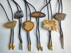 "STRIKING HAND CUT & POLISHED AGATE BOLO TIE UNIQUE rectangular ochre natural geode agate bolo, shows crystal inclusions. Nicely cut and polished with lower organic raw edge. Securely mounted on a sturdy metal slide with easy release clasp. Fitted on a braided black leather cord with unique gold arrowhead bolo tips. Earthy, neutral colors coordinate well with a wide variety of styles. Stone: 2 1/2\" x 2 1/4\", 1/4\" thick Cord length: 36\" Gold arrow head tips: 1 1/4\" x 5/8\" Last photo sho Kimberly Johnson, Tooled Leather Wallet, Gold Arrow, Arrow Head, Boho Belts, Metal Slide, Bolo Tie, Vintage Tools, Agate Necklace