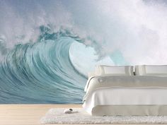 a bedroom with an ocean wave wall mural