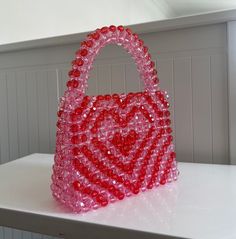 🌸 Handmade Heart-Shaped Beaded Bag: Symbol of Love and Elegance 🌸 Express your style and personality with this unique handmade bag that will make your heart skip a beat! Bringing together elegance and chic, this bag is the perfect accessory to complement your style on special occasions or everyday use. 🎨 Handcrafted Design: Each bead and stitch is meticulously handcrafted with love, making each bag unique and special for you. 💖 Romantic Design: Its heart-shaped design symbolizes romance and Red Beaded Bag As Gift, Red Beaded Bag For Gift, Everyday Red Beaded Bags, Red Embellished Bags For Gift, Red Embellished Bag As A Gift, Valentine's Day Gift Beaded Bag, Heart-shaped Beaded Bag For Gifts, Heart-shaped Beaded Bag As Gift, Red Beaded Bag