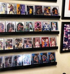 several sports cards are hanging on the wall