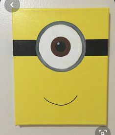 a minion painted on the wall with an eyeball in it's center