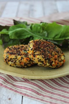 two crab cakes on a plate with lettuce