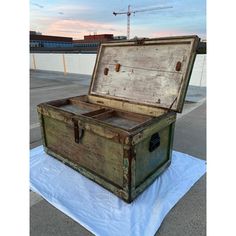 an old trunk sitting on top of a tarp