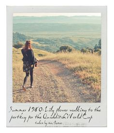 a woman walking down a dirt road with a quote written on the side of it