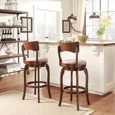 two wooden barstools sitting in front of a window